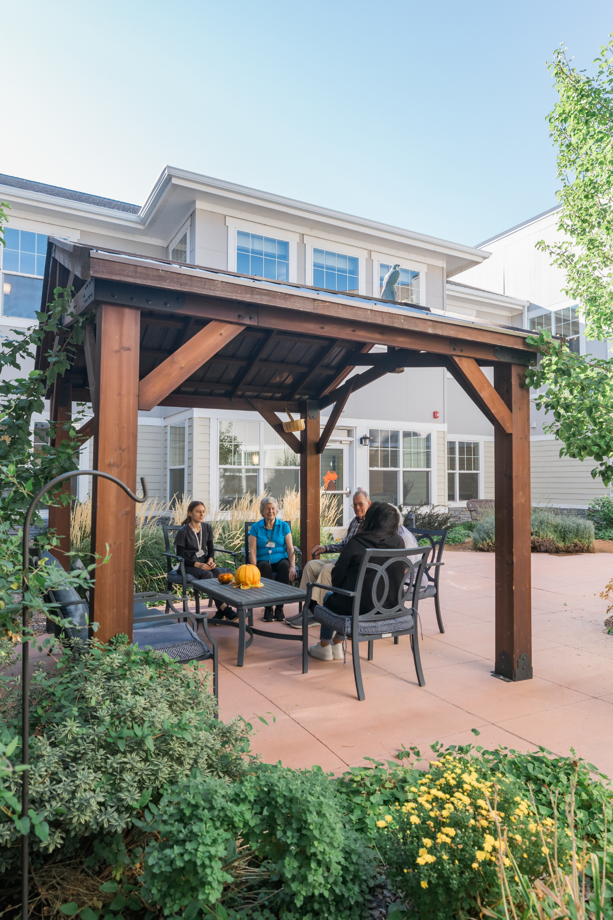 residents and team member enjoying the fall outside on the pergola 7 portrait